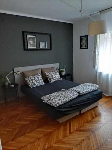 a bedroom with a bed in the middle of a room at Kopernik - parking available in Belgrade