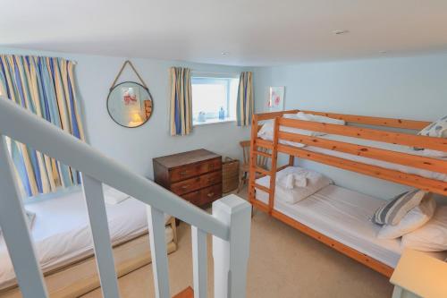 a bedroom with two bunk beds and a window at 7 Nelson Steps in Dartmouth