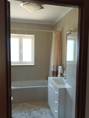 a bathroom with a bath tub and a sink at Casa da rosinha - Minho, Portugal in Arcos de Valdevez