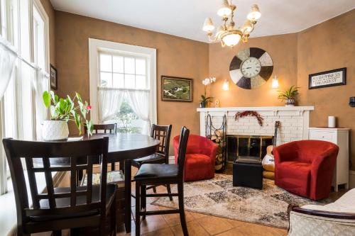 a living room with a table and a fireplace at The Inn on Bay in Gravenhurst