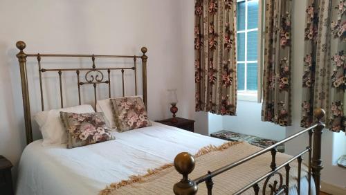 a bedroom with a bed with two pillows on it at Quinta da Barbosa in Folgosinho