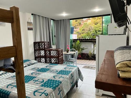 a bedroom with two beds and a balcony at Flat Rosebahia in Morro de São Paulo