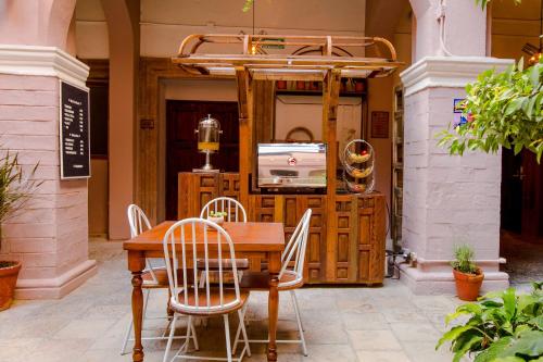 a dining room table with chairs and a television at Selina San Miguel de Allende in San Miguel de Allende