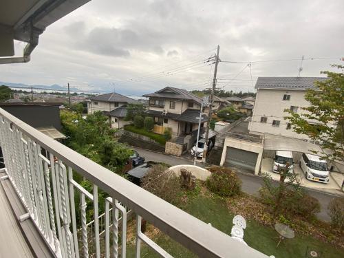 a balcony with a view of a street with houses at 澄心小筑 房东住一楼 客人住二楼 每天只接一组客人 雄琴车站免费接送 提供一台免费停车位 in Otsu