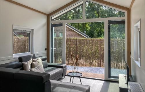 a living room with a couch and a large window at Stunning Home In Putten With Wifi in Putten
