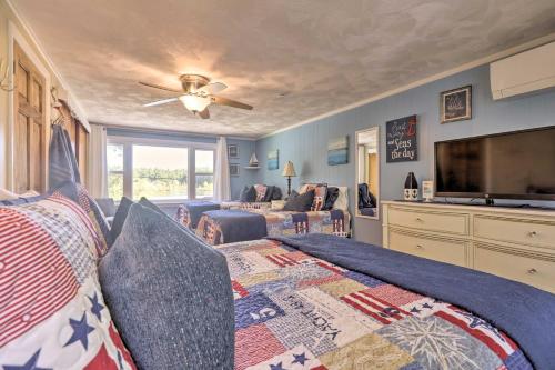 a bedroom with a bed and a flat screen tv at Football Fans Lake Retreat - 5 Mins to Gillette! in Plainville