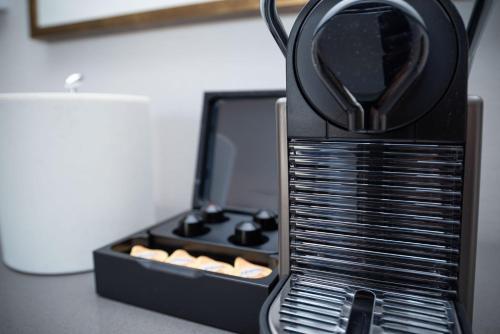 a black toaster sitting on top of a counter at The Sutton Place Hotel Vancouver in Vancouver