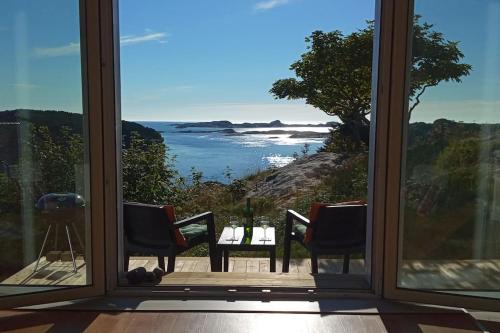 a room with a view of the ocean from a window at Apartment , Øygarden, Bergen in Torsteinsvik