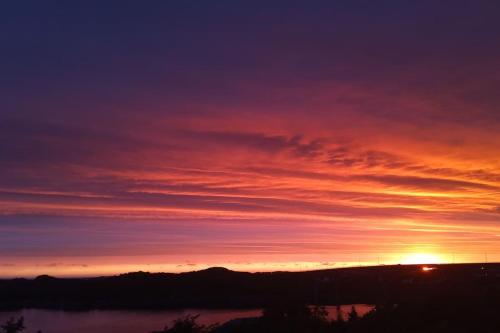 a sunset over a body of water at Apartment , Øygarden, Bergen in Torsteinsvik