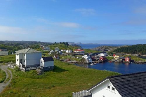 a small town on a hill with a body of water at Apartment , Øygarden, Bergen in Torsteinsvik