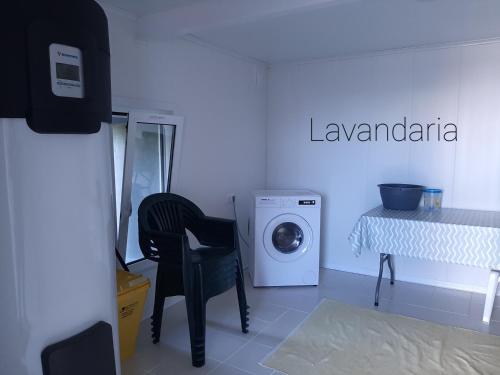 a laundry room with a washing machine and a table at Norverde - Açores in Nordestinho