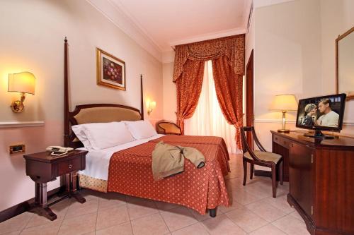 מיטה או מיטות בחדר ב-Hotel Nizza