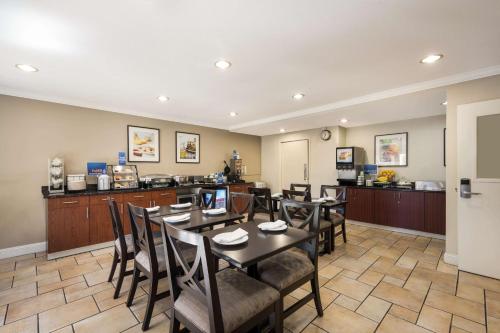 a kitchen with a dining room table and chairs at Best Western Danville Sycamore Inn in Danville