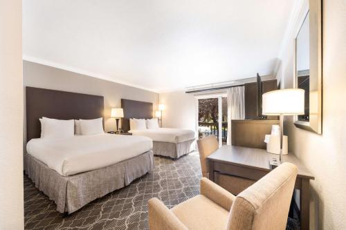 a hotel room with two beds and a desk at Best Western Danville Sycamore Inn in Danville