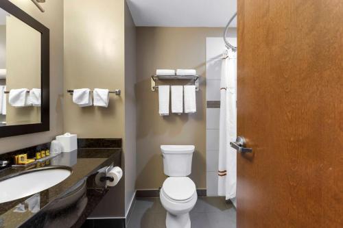 a bathroom with a toilet and a sink at Best Western PLUS Fort Saskatchewan Inn & Suites in Fort Saskatchewan