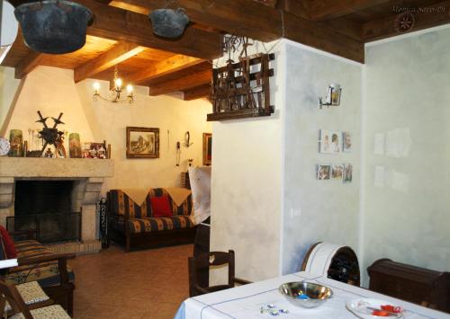 a living room with a table and a fireplace at Tenuta Palma in Sonnino