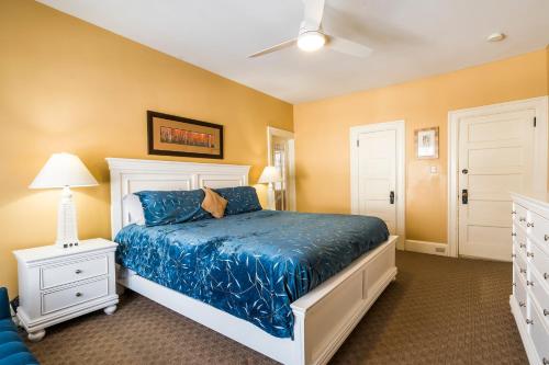 a bedroom with a bed with a blue comforter at The Inn on Bay in Gravenhurst