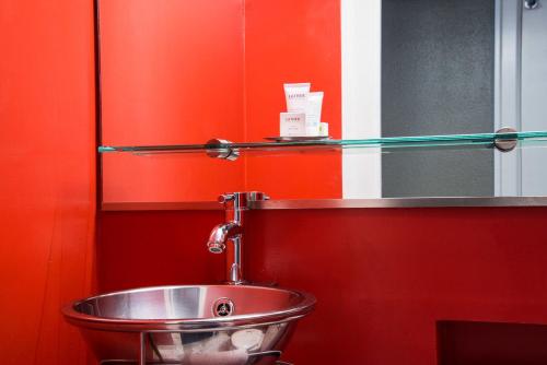 a red and white sink in a bathroom at Hotel Max in Seattle