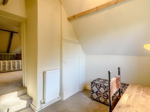 an attic bedroom with a staircase and a closet at The Lodge - Uk32622 in Swannington