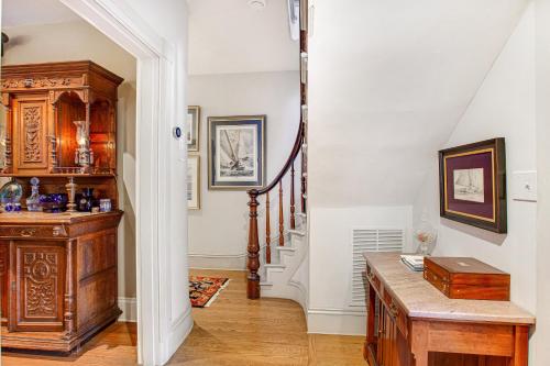 a hallway with a staircase with a wooden table and a stair case at Submariners Gate in Annapolis