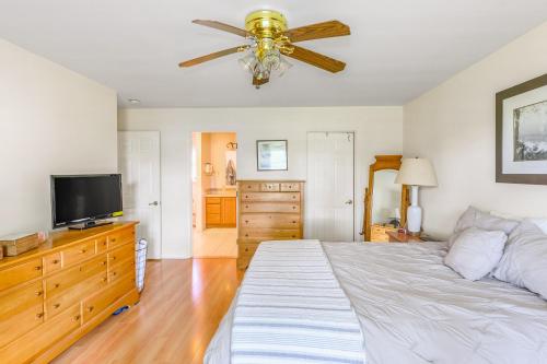 a bedroom with a bed and a flat screen tv at Minnehaha Marvel in Southold
