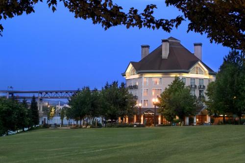 a large building with a bridge in the background at Kimpton Riverplace Hotel, an IHG Hotel in Portland