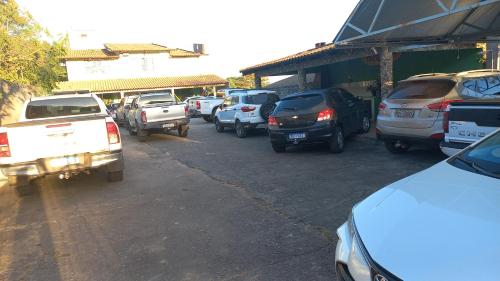 a bunch of cars parked in a parking lot at Pousada Hotel Araguaia in Aragarças