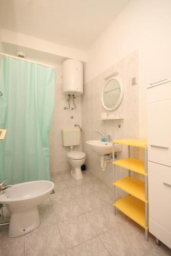 a bathroom with a sink and a toilet and a shower at Apartments with parking space Artatore, Losinj - 8007 in Čunski