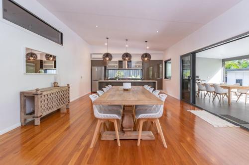 a dining room and kitchen with a table and chairs at The Mac in Smiths Lake