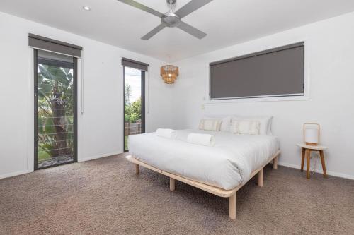 a bedroom with a bed and a flat screen tv at The Mac in Smiths Lake