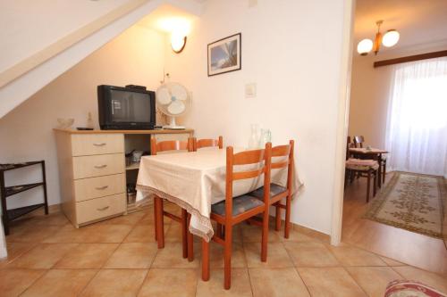 a dining room with a table and a tv at Apartments by the sea Vis - 2477 in Vis
