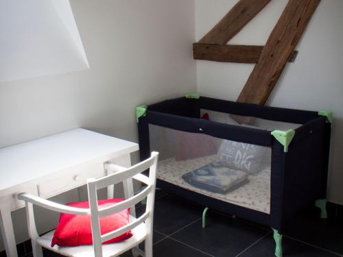 a room with a desk and a table and a chair at Gîte spacieux avec piscine chauffée, wifi et tennis au bord de la Loire - FR-1-590-97 in Sigloy