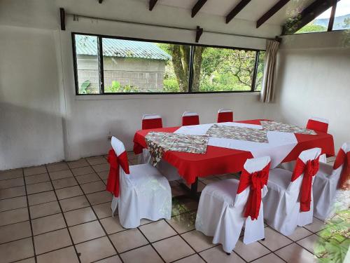 a room with a table and chairs with red bows at Hotel Villa Zurqui in San José