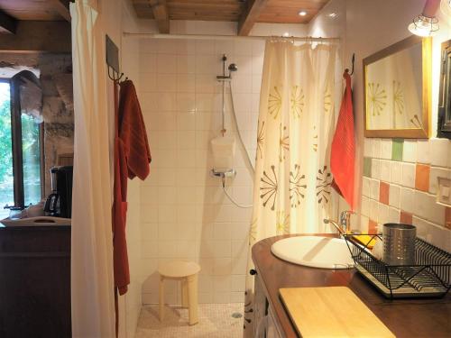 a bathroom with a sink and a shower curtain at holiday home, Grignan in Gourdon