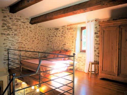 a room with a metal bunk bed in a brick wall at holiday home, Grignan in Gourdon