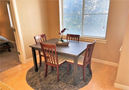 a dining room table and chairs in a room with a window at 1-Bedroom Condo in the Heart of the City in Salt Lake City