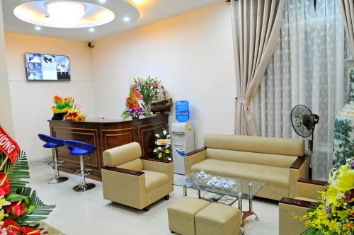 a waiting room with a couch and a table at Lotus Apartment Hotel in Vung Tau