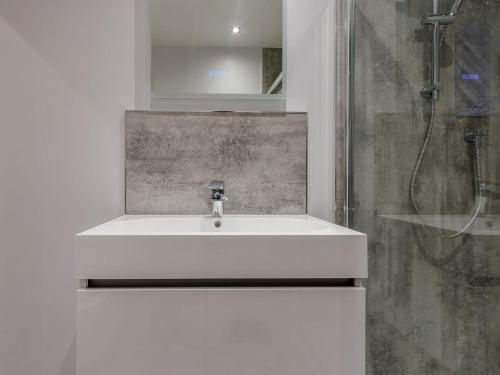 a bathroom with a white sink and a shower at Fairview in Penicuik