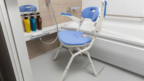 a blue chair sitting in a bathroom next to a sink at JR East Hotel Mets Premier Tokyo Bay Shinkiba in Tokyo