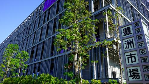 a building with a tree in front of it at JR East Hotel Mets Premier Tokyo Bay Shinkiba in Tokyo
