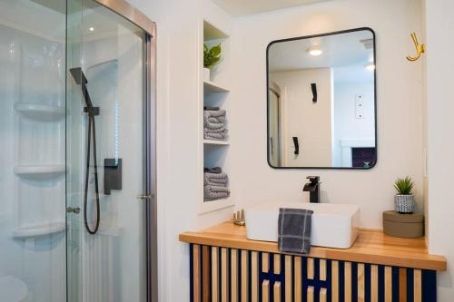 a bathroom with a sink and a mirror at Cozy modern tiny home near ZION & private deck in Apple Valley