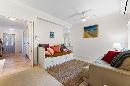 a living room with a couch and a table at Wave Haven in Dalmeny