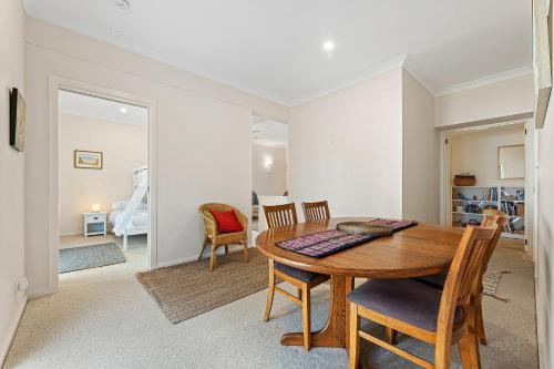 a dining room with a wooden table and chairs at Wave Haven in Dalmeny