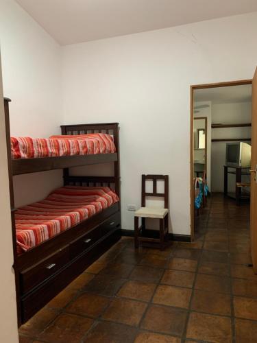 a bedroom with two bunk beds and a mirror at Casa Cafayate in Cafayate
