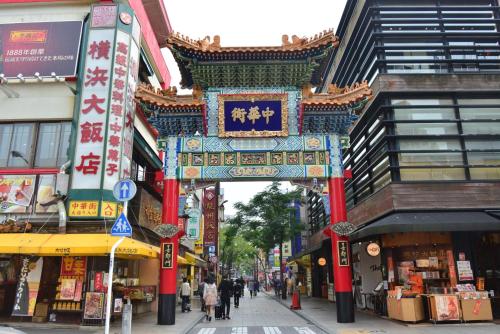 a street in an asian city with a chinese arch at JR East Hotel Mets Premier Yokohama Sakuragicho in Yokohama
