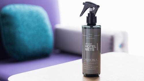 a black spray bottle sitting on a table at JR-East Hotel Mets Urawa in Saitama