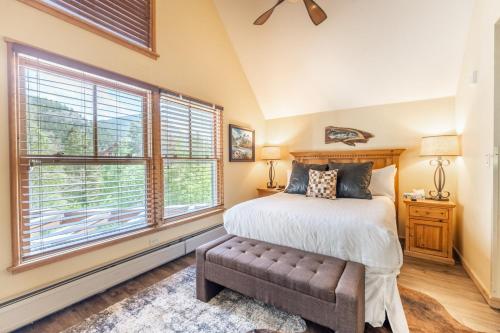 a bedroom with a bed and a large window at Jackpine Lodge by Summit County Mountain Retreats in Keystone