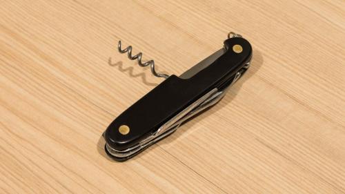 a black knife sitting on top of a wooden table at JR-East Hotel Mets Tsudanuma in Narashino