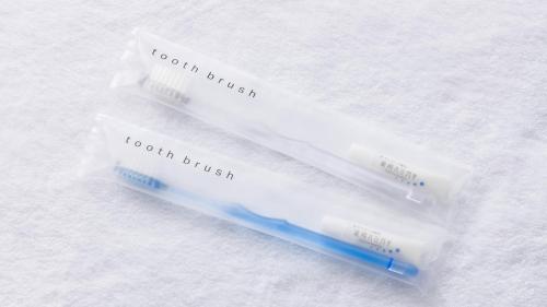 two toothbrushes sitting on top of a towel at JR East Hotel Mets Premier Sapporo in Sapporo