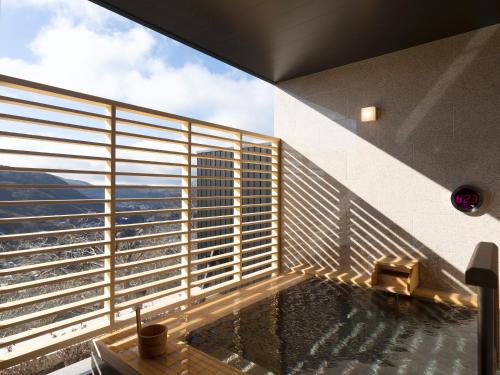 a balcony of a building with a view of the city at Hotel Shikinoyakata Hakone Ashinoko in Hakone